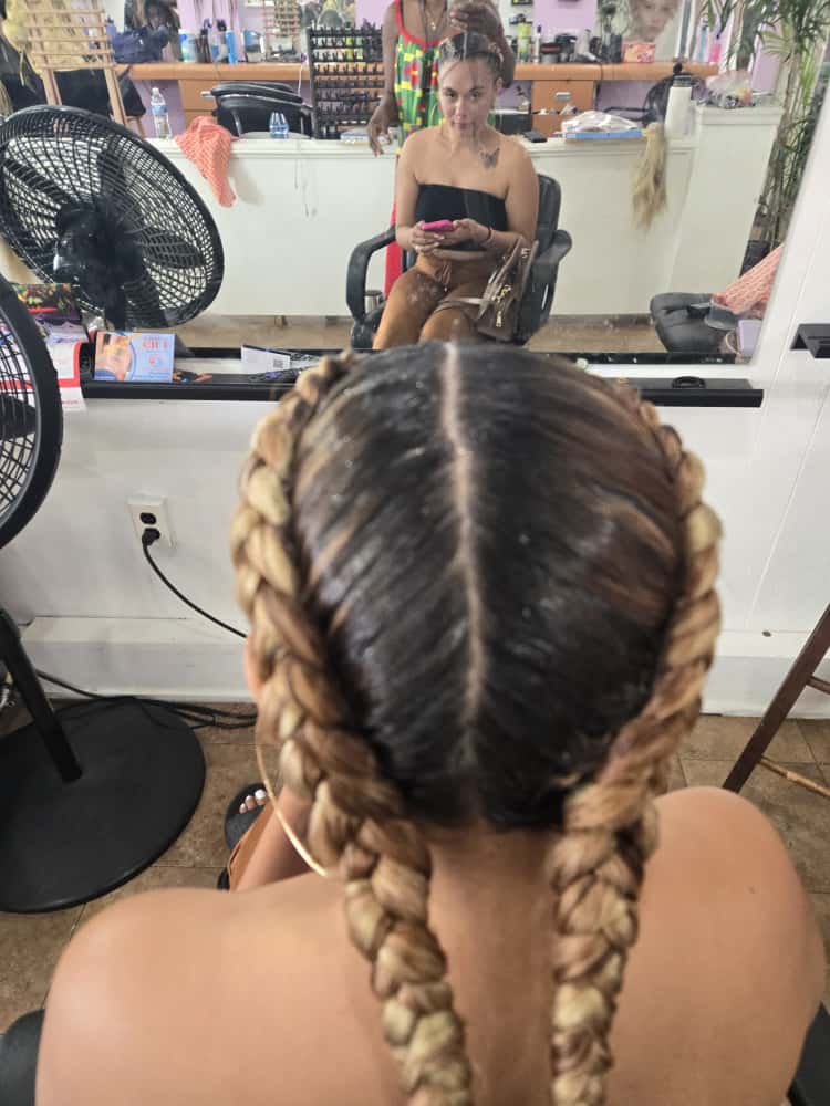 Two-cornrow style by Akwaba Hair Braiding